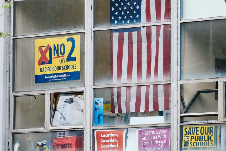 A sign against a ballot question to lift the cap on charter schools in Massachusetts is seen at McKinley South End Academy in Boston on Sept. 28, 2016.